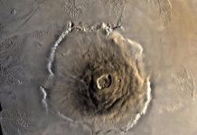 What Is The Largest Volcano In The Solar System? Olympus Mons, Mars | Image From NASA.gov. Taken during Viking 1 Orbiter Mission on 22 June 1978.