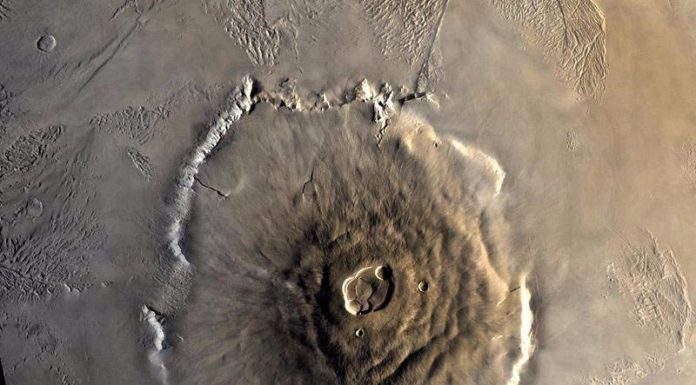 What Is The Largest Volcano In The Solar System? Olympus Mons, Mars | Image From NASA.gov. Taken during Viking 1 Orbiter Mission on 22 June 1978.